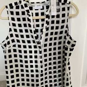 Sleeveless blouse with button detailing.